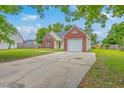 Residential house featuring a well-maintained lawn, concrete driveway, and an attached single-car garage at 206 Barnwell St, Summerville, SC 29483