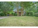 Quaint home with a well-manicured lawn, complemented by lush trees and shrubbery at 2177 Gulf Dr, Mount Pleasant, SC 29464