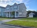 Charming two-story home with a landscaped front yard and a detached two car garage at 232 Ashworth Dr, Summerville, SC 29486