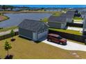View of the detached garage, which has parking for two cars, next to a home with a lake in the background at 232 Ashworth Dr, Summerville, SC 29486