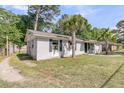 Quaint home exterior showcasing a side view, complemented by lush green grass and convenient backyard access at 242 Amy Dr, Goose Creek, SC 29445