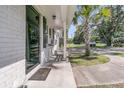 Inviting entryway with a 'Hello' mat, exterior lights, and dark-trimmed windows creating a warm, welcoming facade at 242 Amy Dr, Goose Creek, SC 29445