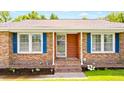 Close up of a home's inviting front porch with blue shutters and brickwork details at 264 Columbia Dr, Ladson, SC 29456