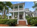 Charming two-story home with double porches, brick stairs and manicured landscaping at 2792 River Vista Way, Mount Pleasant, SC 29466