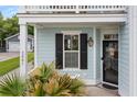 Cozy covered entryway featuring lush greenery and a stylish exterior light fixture at 2881 Rutherford Way, Charleston, SC 29414