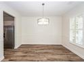 Open dining room with hardwood floors, chair rail and decorative trim, and stainless steel appliances visible at 2947 Sweetleaf Ln, Johns Island, SC 29455