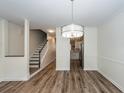 Bright, open-concept dining room with hardwood floors, modern lighting, and trimwork at 2947 Sweetleaf Ln, Johns Island, SC 29455