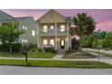 Charming two-story home with a welcoming porch swing and double balconies during a lovely sunset at 2961 Waterleaf Rd, Johns Island, SC 29455