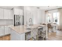 Bright kitchen with white cabinets, stainless steel appliances, and a center island with seating at 308 Archar St, Summerville, SC 29486