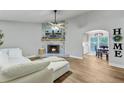 Cozy living room with a stone fireplace and an archway to the dining area at 309 Kingbird Rd, Ladson, SC 29456