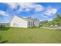 Well-maintained single-story home with lush green lawn and charming exterior at 311 Beachgrass Ln, Summerville, SC 29486