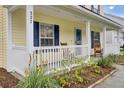Inviting front porch with classic rocking chairs, framed by a well-maintained lawn and vibrant plants at 327 Eagle Ridge Rd, Summerville, SC 29485