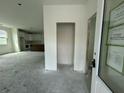 Spacious entryway leading to a kitchen with white cabinets and an island at 333 Trailmore Ln, Summerville, SC 29486