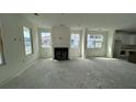 Open living room with a cozy fireplace and large windows for ample natural light at 333 Trailmore Ln, Summerville, SC 29486