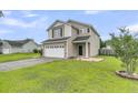 Charming two-story home with a manicured lawn and an attached two-car garage at 423 Watershed Dr, Goose Creek, SC 29445