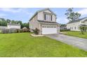 Two-story home with a well-kept lawn and a two-car garage in a residential neighborhood at 423 Watershed Dr, Goose Creek, SC 29445