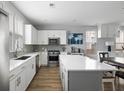 Open kitchen featuring white cabinets, quartz countertops, and stainless steel appliances at 4621 Holmes Ave, North Charleston, SC 29405