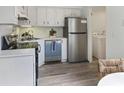 Bright kitchen with stainless steel appliances, white cabinets, and durable, new floors at 519 Parkdale Dr # J, Charleston, SC 29414