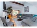 Spacious living room with a fireplace, hardwood floors, a large sofa, and glass doors to another room at 554 Double Eagle Trce, Seabrook Island, SC 29455