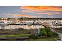 Scenic marina view with boats docked along the pier and beautiful sky at sunset at 63 Mariners Cay, Folly Beach, SC 29439