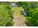 Aerial view highlights the spacious, well-maintained lot featuring grassy areas and accessory buildings at 7239 Commodore Rd, Hollywood, SC 29449