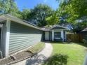 Charming home featuring a curved walkway, fresh exterior paint and a well-manicured lawn at 8254 Timberidge Ct, North Charleston, SC 29420