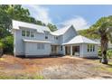 Home with white siding and a bright metal roof with freshly prepped landscaping at 931 Kincade Dr, Mount Pleasant, SC 29464