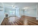 Bright living room showcasing hardwood floors, fireplace, and light-blue walls with large windows for natural light at 1025 Riverland Woods Pl # 904, Charleston, SC 29412