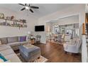 Cozy living room with hardwood floors, a comfortable sofa, and seamless access to the dining area at 104 Hyacinth St, Summerville, SC 29483