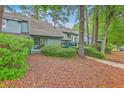 Exterior view of a townhome featuring lush greenery and a well-maintained lawn at 1115 Shadow Lake Cir, Mount Pleasant, SC 29464