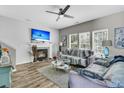 Comfortable living room with a fireplace, ceiling fan, and natural light from the many bright windows at 113 Southernwood Dr, Ladson, SC 29456