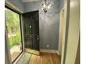 Inviting entryway with a stylish chandelier, wooden floors, and a view of the outdoors through the open door at 116 W 5Th South St # D, Summerville, SC 29483