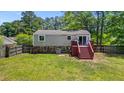 Exterior view of the back of the home featuring a large wooden deck and spacious yard at 117 Canaberry Cir, Summerville, SC 29483