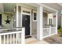 Up close view of the front door and porch area, showing the unit's entrance and trim details at 1225 Blakeway St # 407, Charleston, SC 29492