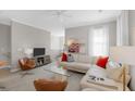 Cozy living room featuring a white leather couch, modern furnishings, and ample natural light at 1225 Blakeway St # 407, Charleston, SC 29492