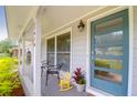 Inviting front porch with chairs and a teal door at 1416 Glencoe Dr, Mount Pleasant, SC 29464