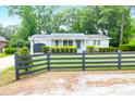 Charming gray home with dark fence, green lawn, and landscaping at 1416 Glencoe Dr, Mount Pleasant, SC 29464