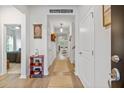 Bright hallway showcasing hardwood floors, white walls, and inviting decor leading to other rooms at 148 Haverhill St, Summerville, SC 29486