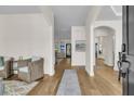 Bright foyer with wood floors, elegant archways, and a view into the living room at 1517 Faith St, Mount Pleasant, SC 29466