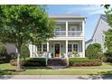 Inviting two-story home with a covered porch, manicured landscaping, and a charming entrance at 1527 Wando View St, Charleston, SC 29492