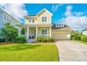 Inviting two-story home boasting a classic front porch, manicured landscaping, and a convenient attached garage, perfect for families at 1545 Calaveras Cir, Mount Pleasant, SC 29466