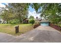 View of a home's brick driveway leading to a light-blue garage door at 1603 Culpepper Cir, Charleston, SC 29407