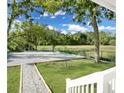 Scenic backyard features a gravel area and lawn, complemented by lush trees and blue skies at 1915 Quitman St, North Charleston, SC 29405