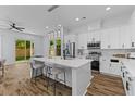 Modern kitchen boasts an island with seating, stainless steel appliances, and a seamless transition to the outdoor space at 1989 Groveland Ave, North Charleston, SC 29405