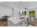 Open kitchen design featuring an island with sink, modern pendant lighting, stainless appliances, and an adjacent living area at 1989 Groveland Ave, North Charleston, SC 29405