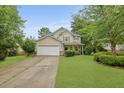 Attractive two-story home with lush green lawn, two car garage and covered front porch at 200 Commencement Blvd, Ladson, SC 29456