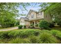 Well-maintained two-story home with a two-car garage, lush landscaping, and a welcoming front porch at 200 Commencement Blvd, Ladson, SC 29456