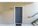 Exterior view of the front door with 'P' designation, a welcome mat, and a wall-mounted lantern at 2011 N Highway 17 # 1400P, Mount Pleasant, SC 29466