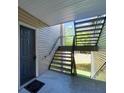 A view of the front door and exterior staircase leading to the unit, complemented by a welcome mat at 2011 N Highway 17 # 1400P, Mount Pleasant, SC 29466