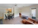 Inviting living room with light wood floors, a cozy chair, dining table with black chairs, and view into the kitchen at 2011 N Highway 17 # 1400P, Mount Pleasant, SC 29466